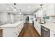 Spacious kitchen featuring white cabinets, stainless steel appliances, and a large island at 8810 W Tulip Tree Dr, Muncie, IN 47304