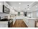 Modern kitchen with white cabinets, stainless steel appliances, and island at 8810 W Tulip Tree Dr, Muncie, IN 47304