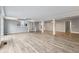 Open living area with hardwood floors, fireplace, and spiral staircase at 8810 W Tulip Tree Dr, Muncie, IN 47304