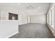 Bright living room with vaulted ceiling, carpet, and multiple windows at 8810 W Tulip Tree Dr, Muncie, IN 47304