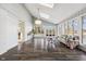 Bright sunroom with lots of windows, hardwood floors, and comfortable seating at 8810 W Tulip Tree Dr, Muncie, IN 47304