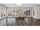 Sunroom addition with hardwood floors, large windows, and a cozy sitting area at 8810 W Tulip Tree Dr, Muncie, IN 47304