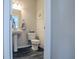 Cozy half-bathroom featuring modern fixtures, neutral tones, and wood-style flooring at 1001 Parker Ln, Westfield, IN 46074