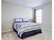 Comfortable bedroom with a window, carpet, and a bed with striped bedding at 1001 Parker Ln, Westfield, IN 46074