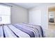 Comfortable bedroom with a closet, carpet, and a bed with striped bedding at 1001 Parker Ln, Westfield, IN 46074