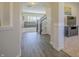 Welcoming foyer with sleek wood floors, staircase, and an open view into the living area at 1001 Parker Ln, Westfield, IN 46074