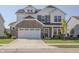 Charming two-story home featuring a stone facade, attached two-car garage, and manicured front yard at 1001 Parker Ln, Westfield, IN 46074
