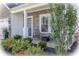 Charming front porch with stone accents, seating, and manicured landscaping at 1001 Parker Ln, Westfield, IN 46074