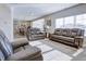 Bright and airy living room featuring leather seating, and an open floor plan to the kitchen and dining area at 1001 Parker Ln, Westfield, IN 46074