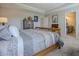 Comfortable main bedroom features neutral tones, carpet, a walk-in closet, and an ensuite bath at 1001 Parker Ln, Westfield, IN 46074