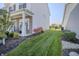 Well-maintained side yard with lush grass, stone accents, and manicured landscaping at 1001 Parker Ln, Westfield, IN 46074