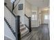 Elegant staircase featuring carpeted steps, dark wood accents, and a bright, airy design at 1001 Parker Ln, Westfield, IN 46074
