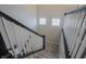 Carpeted staircase with white railing and black banister ascends past bright windows at 1001 Parker Ln, Westfield, IN 46074