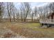 Large backyard with mature trees and a sloped terrain at 1084 Chipmunk Ln, Pendleton, IN 46064