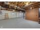 Unfinished basement with exposed beams, concrete floor, and shelving at 1084 Chipmunk Ln, Pendleton, IN 46064