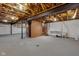 Unfinished basement with exposed beams, concrete floor, and shelving at 1084 Chipmunk Ln, Pendleton, IN 46064