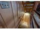 Wooden staircase leading down to a partially finished basement at 1084 Chipmunk Ln, Pendleton, IN 46064