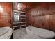 White bathtub and marble floor in rustic bathroom at 1084 Chipmunk Ln, Pendleton, IN 46064