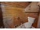 Rustic bathroom with toilet and wood walls at 1084 Chipmunk Ln, Pendleton, IN 46064