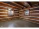 Cozy bedroom with log walls and hardwood floors at 1084 Chipmunk Ln, Pendleton, IN 46064