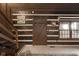 Rustic entryway with log cabin walls, wooden staircase, and a unique door at 1084 Chipmunk Ln, Pendleton, IN 46064