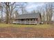 Rustic log cabin with wrap-around porch and wooded lot at 1084 Chipmunk Ln, Pendleton, IN 46064