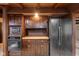 Rustic kitchen with wooden cabinets, appliances, and a large window at 1084 Chipmunk Ln, Pendleton, IN 46064