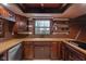 Rustic kitchen with wooden cabinets, wood countertops, and a window with a view at 1084 Chipmunk Ln, Pendleton, IN 46064