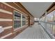 Covered porch with wooden railings and log cabin siding at 1084 Chipmunk Ln, Pendleton, IN 46064