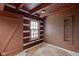 Simple room with log cabin walls, a window, and a small rug at 1084 Chipmunk Ln, Pendleton, IN 46064