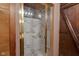 Shower with marble tiles and brass frame at 1084 Chipmunk Ln, Pendleton, IN 46064
