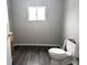 Clean bathroom with grey walls, a toilet, and dark grey vinyl flooring at 1128 N Holmes Ave, Indianapolis, IN 46222