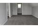 Simple bedroom with grey carpeting and access to a bathroom at 1128 N Holmes Ave, Indianapolis, IN 46222
