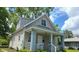 An appealing view of home's exterior, showing its architectural details and siding, under a partly cloudy sky at 1128 N Holmes Ave, Indianapolis, IN 46222