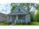 Inviting front view of home, showcasing its charming architecture and well-maintained exterior with front porch at 1128 N Holmes Ave, Indianapolis, IN 46222