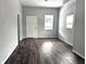 Spacious living area with gray walls and dark wood flooring at 1128 N Holmes Ave, Indianapolis, IN 46222