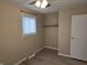Simple bedroom with ceiling fan, window, and closet at 117 Tracy Rd, Whiteland, IN 46184