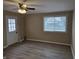 Bright bedroom with neutral walls, hardwood floors, and a window with blinds at 117 Tracy Rd, Whiteland, IN 46184