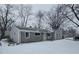Gray vinyl-sided ranch home with stone accents, snowy front yard at 117 Tracy Rd, Whiteland, IN 46184