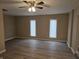 Spacious living room featuring wood-look floors, neutral walls, and a ceiling fan at 117 Tracy Rd, Whiteland, IN 46184