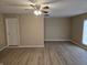 Spacious living room with light walls, laminate flooring, and ceiling fan at 117 Tracy Rd, Whiteland, IN 46184