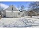 Snow-covered backyard of a charming white house at 1218 N Grant Ave, Indianapolis, IN 46201