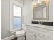 Updated bathroom with white vanity and marble shower at 1218 N Grant Ave, Indianapolis, IN 46201