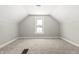 Charming attic bedroom with gray carpet and window at 1218 N Grant Ave, Indianapolis, IN 46201