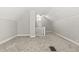 Spacious bonus room with carpet and access to stairs at 1218 N Grant Ave, Indianapolis, IN 46201