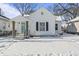 Charming white house with a snow-covered yard at 1218 N Grant Ave, Indianapolis, IN 46201