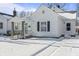 Quaint white house with a snow-covered front yard at 1218 N Grant Ave, Indianapolis, IN 46201