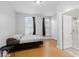 Spacious bedroom with wood floors and en-suite bathroom at 128 Wisconsin St, Indianapolis, IN 46225