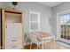 Small dining area with wooden table and white chairs at 128 Wisconsin St, Indianapolis, IN 46225