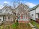 Two-story house with a tree in front and gray siding at 128 Wisconsin St, Indianapolis, IN 46225